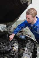 Car mechanic working on engine