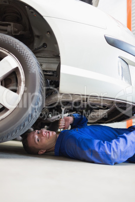 Auto mechanic working under car