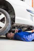 Auto mechanic working under car