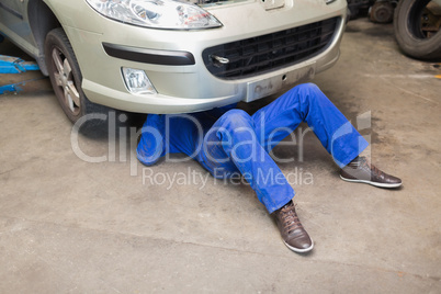 Mechanic under car
