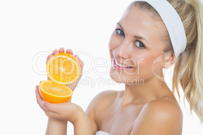 Portrait of happy woman holding orange slices