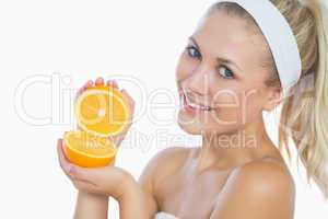 Portrait of happy woman holding orange slices