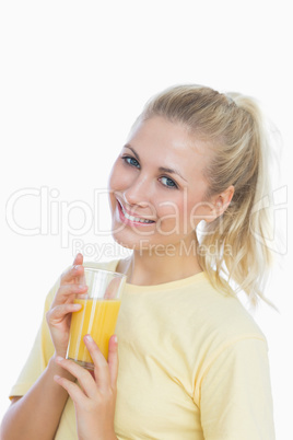 Happy woman holding glass of orange juice