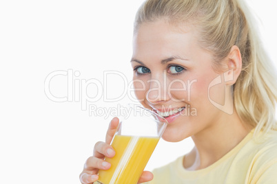 Portrait of happy woman drinking orange juice
