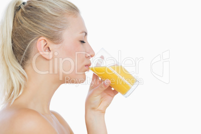 Beautiful woman drinking orange juice