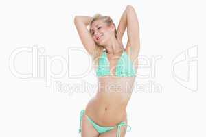Sensuous young woman in green bikini