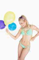 Cheerful woman holding balloons