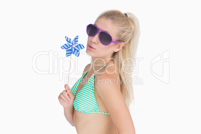 Young woman playing with pinwheel