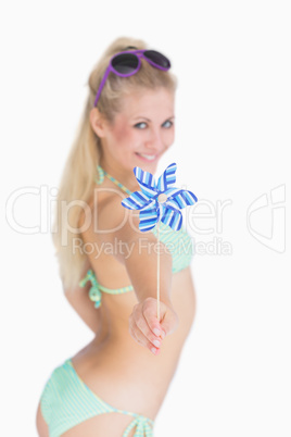 Happy woman offering pinwheel