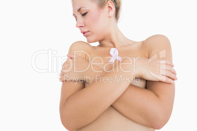 Naked woman with breast cancer ribbon