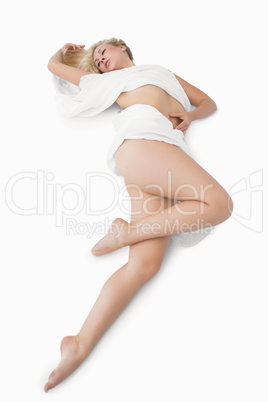 Female wrapped in cloth lying on floor