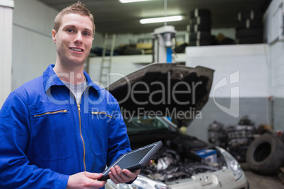 Male mechanic with digital tablet at garage