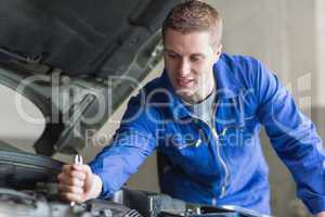 Mechanic working on automobile engine