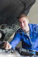 Auto mechanic working on motor