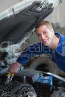 Mechanic working on car engine