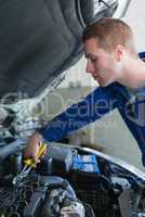 Mechanic working on car engine