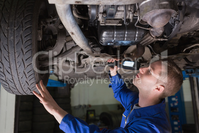 Mechanic examining car