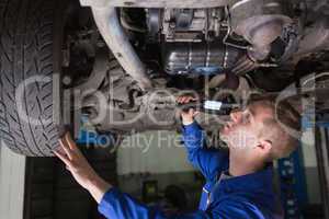 Mechanic examining car