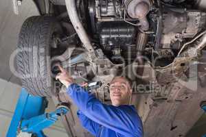 Auto mechanic examining car tire