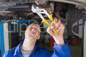 Mechanic repairing car with adjustable pliers