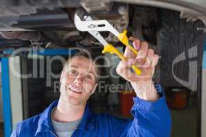 Man repairing car with pliers