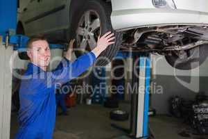 Auto mechanic adjusting car tire