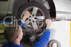 Mechanic fixing car tire