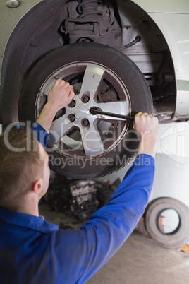 Mechanic fixing car wheel