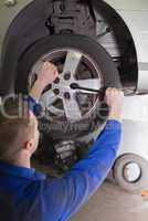 Mechanic fixing car wheel