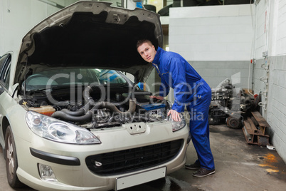 Mechanic examining car engine