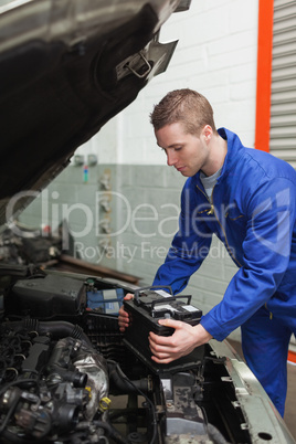 Mechanic checking car battery