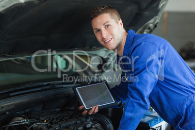 Male mechanic holding tablet pc