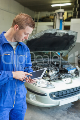 Male mechanic using digital tablet