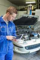 Male mechanic using digital tablet