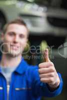 Repairman gesturing thumbs up