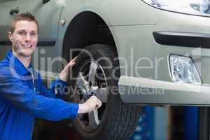 Auto mechanic changing car tire