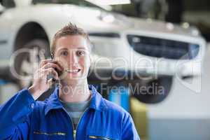 Car mechanic using mobile phone