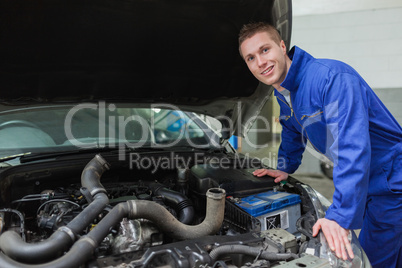 Mechanic working under car bonnet