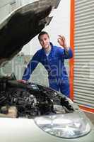 Mechanic by car making ok sign