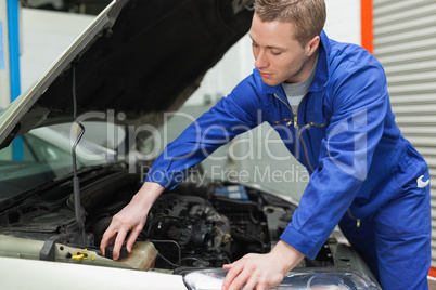 Mechanic closing the lid of windshield washer tank