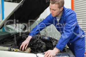 Mechanic closing the lid of windshield washer tank