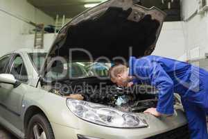 Mechanic working under car bonnet