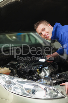 Repairman examining car engine