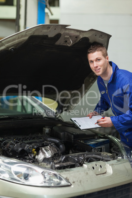 Auto mechanic inspecting car