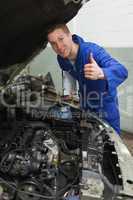 Confident mechanic gesturing thumbs up