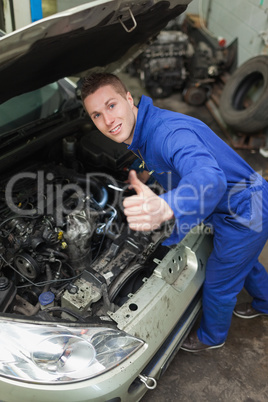 Auto mechanic showing thumbs up sign