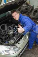 Auto mechanic showing thumbs up sign