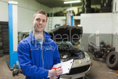 Mechanic writing on clipboard