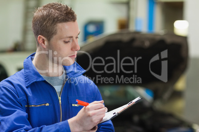 Mechanic writing on clipboard