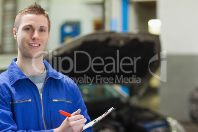 Happy mechanic with clipboard